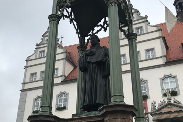 Statue of a man holding a book.