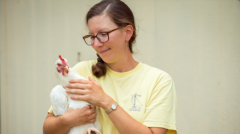 SJC alum Heather Ganz holding a chicken.