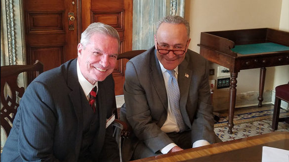 SJC President Donald Boomgaarden sits with U.S. Sen. Chuck Schumer (D-N.Y.).