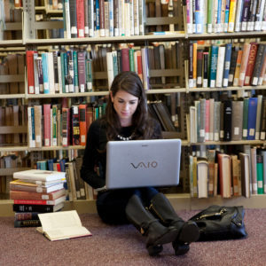 Student studying at SJC Long Island's Callahan Library.