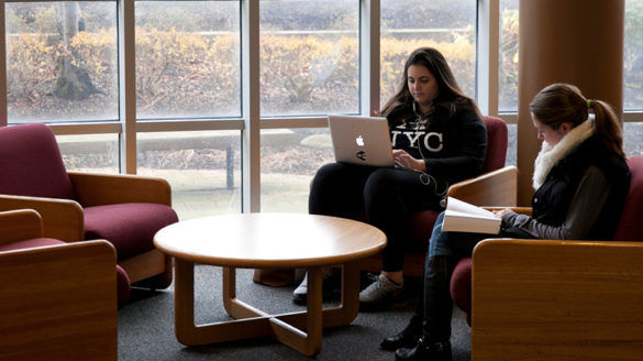 Female students studying in library.