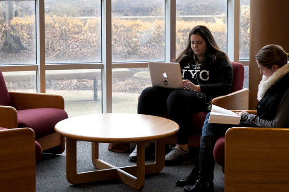 Female students studying in library.