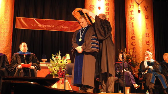 President is hooded at ceremony.