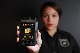 Police officer holding a body-worn camera