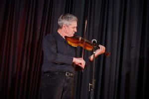 President Boomgaarden playing fiddle