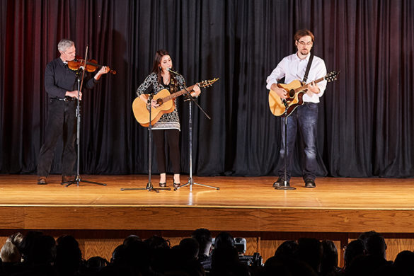 Three people on a stage.