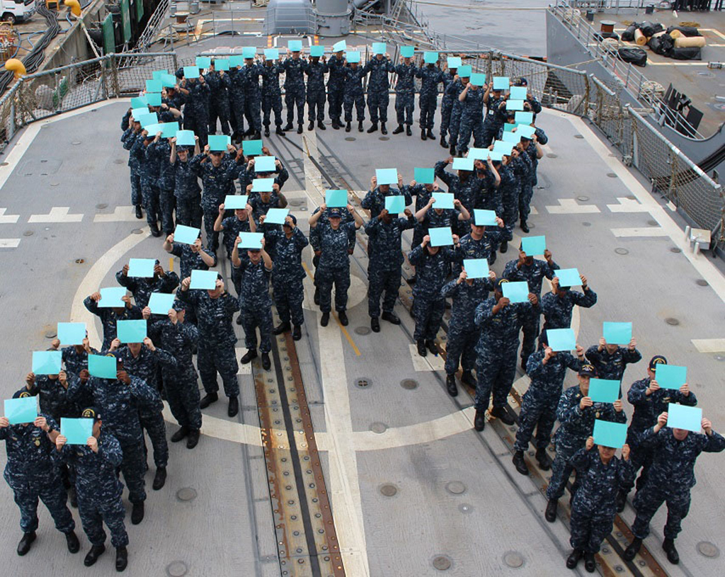 Sailors forming teal ribbon