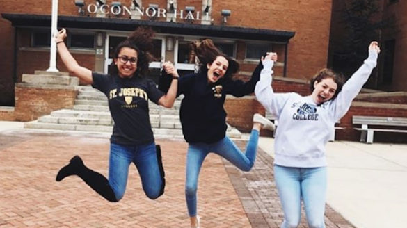 Students jumping for joy at College.