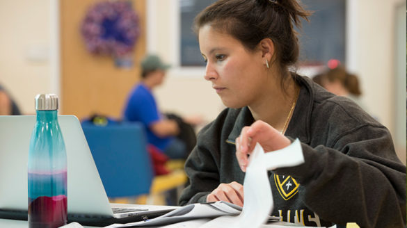 SJC student working on her laptop.