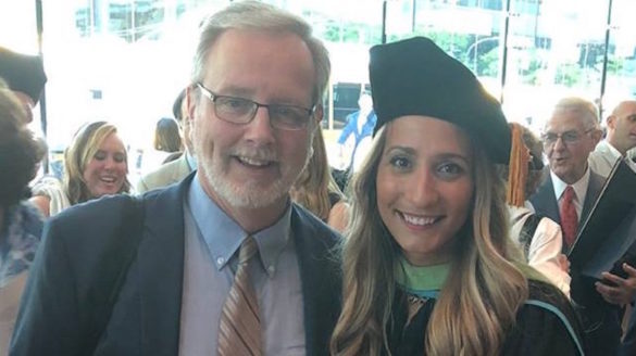 Two adults at a graduation.