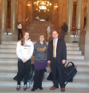 Students and staff member on the steps of the Capitol building in Albany, New York.