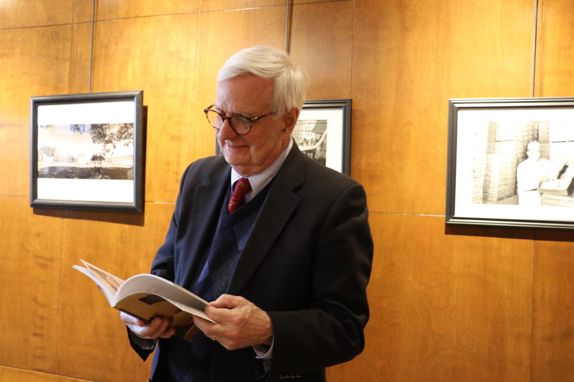 Dr. Thomas Travis holding his copy of the book.