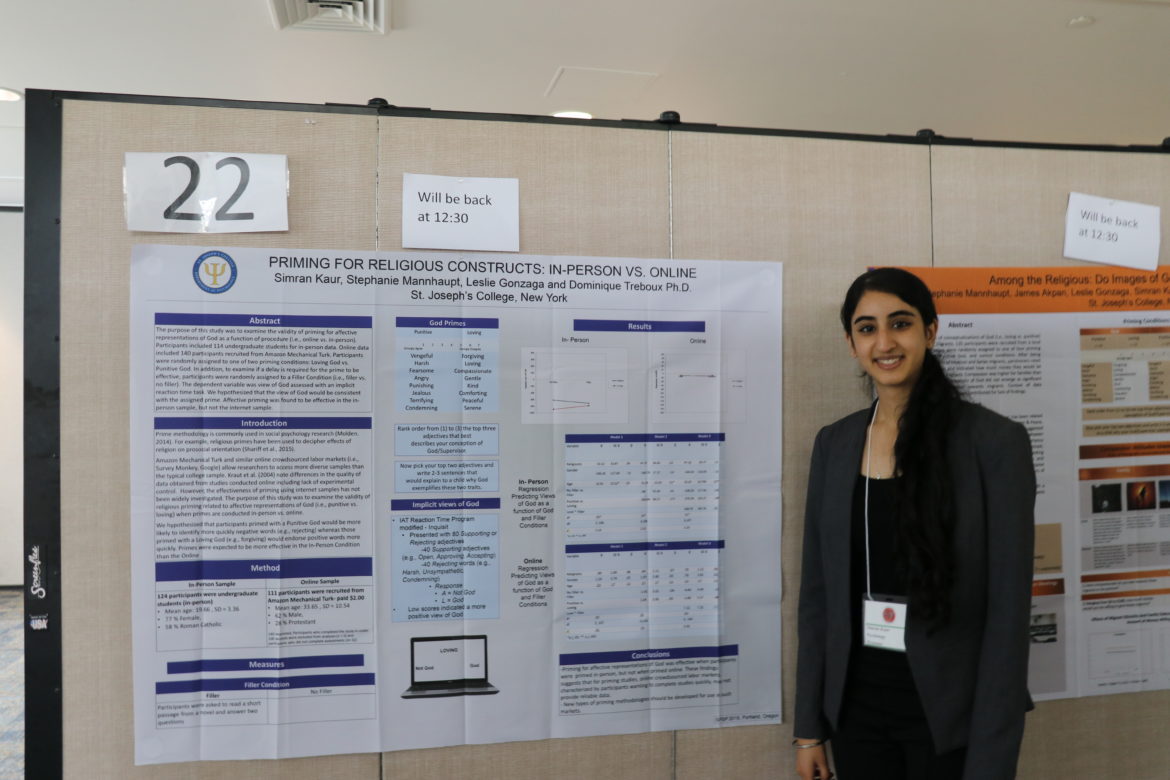 Simran Kaur in front of one of her research posters.