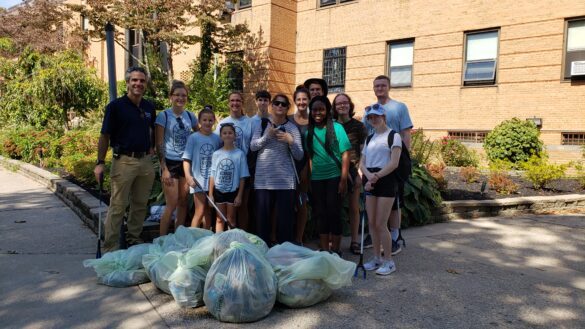 SJC Long Island faculty, students and friends stand with the garbage they collected from the Patchogue Lake behind O'Connor Hall.