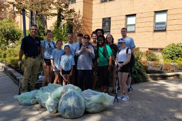 SJC Long Island faculty, students and friends stand with the garbage they collected from the Patchogue Lake behind O'Connor Hall.