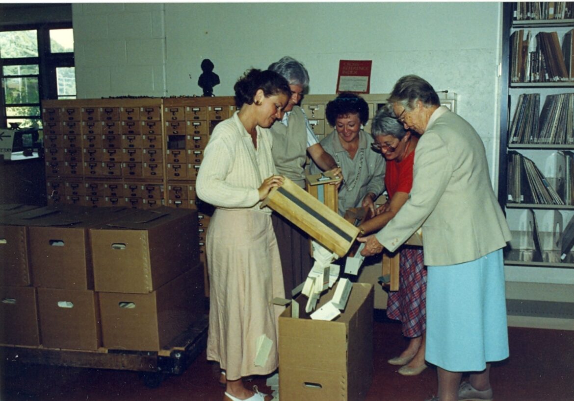 Staff members packing up the card catalogue from when the library was on the first floor of O'Connor Hall.