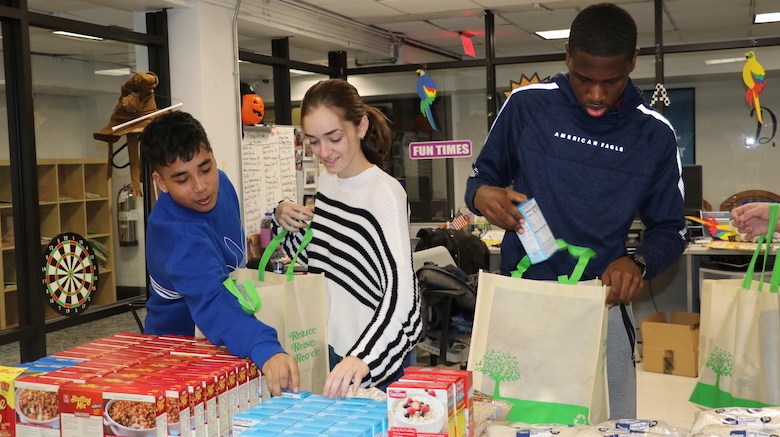 Students at SJC Brooklyn donate and pack Thanksgiving meals for those in need in the local community.