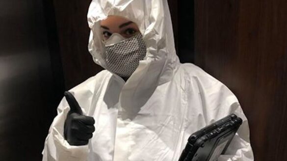 Woman in protective white suit.