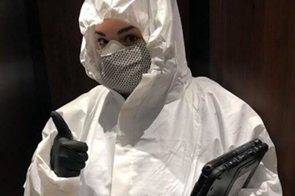 Woman in protective white suit.