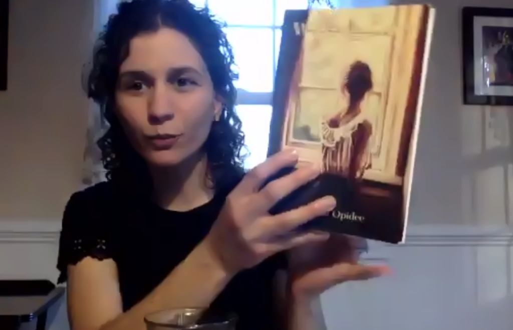 Ioanna Opidee holding up her book "Waking Slow."