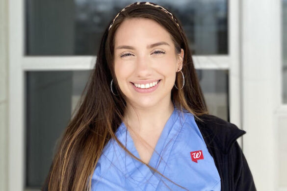 College student dressed for work and smiling.