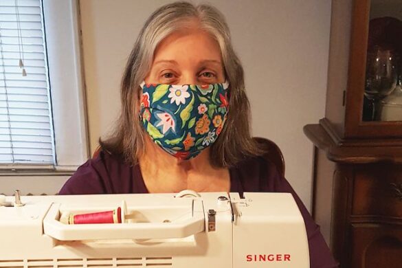 Woman sewing and wearing a mask.