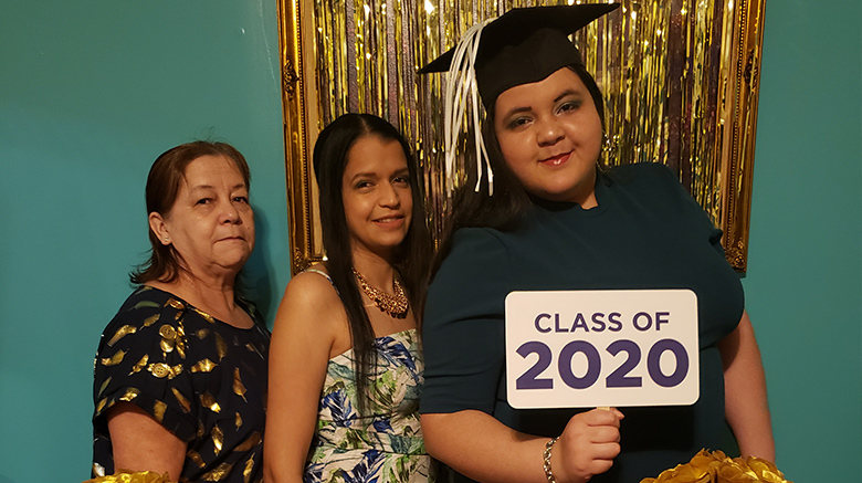 Carmen documenting her graduation from SJC Brooklyn with her family.