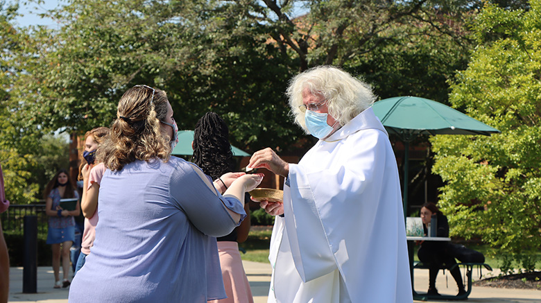Fr. Frank handing out communion.
