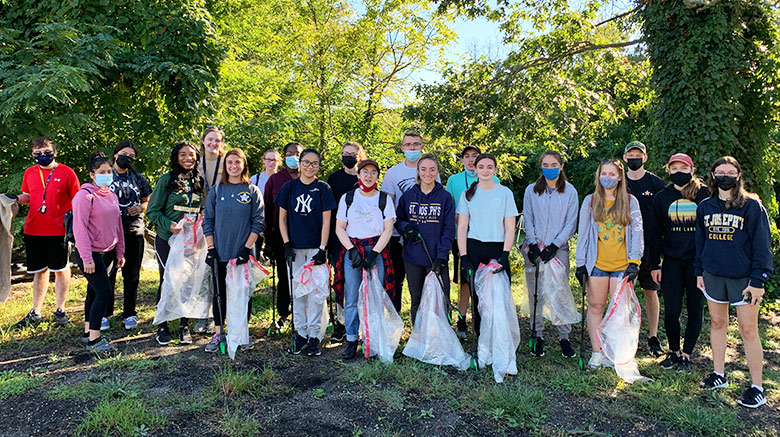 SJC community participating in the Patchogue River Clean Up.