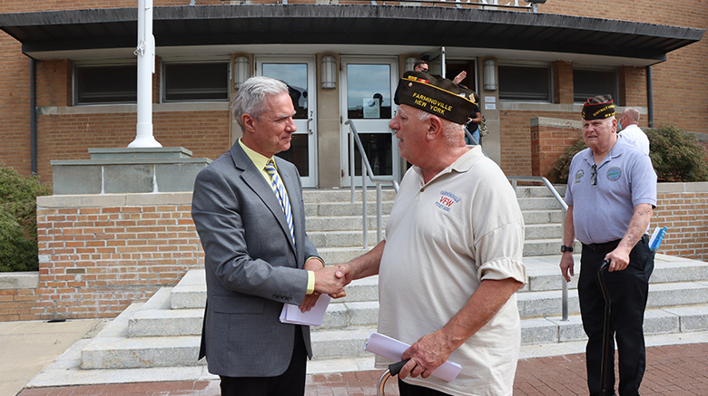 Dr. Boomgaarden shaking hands with a local veteran.