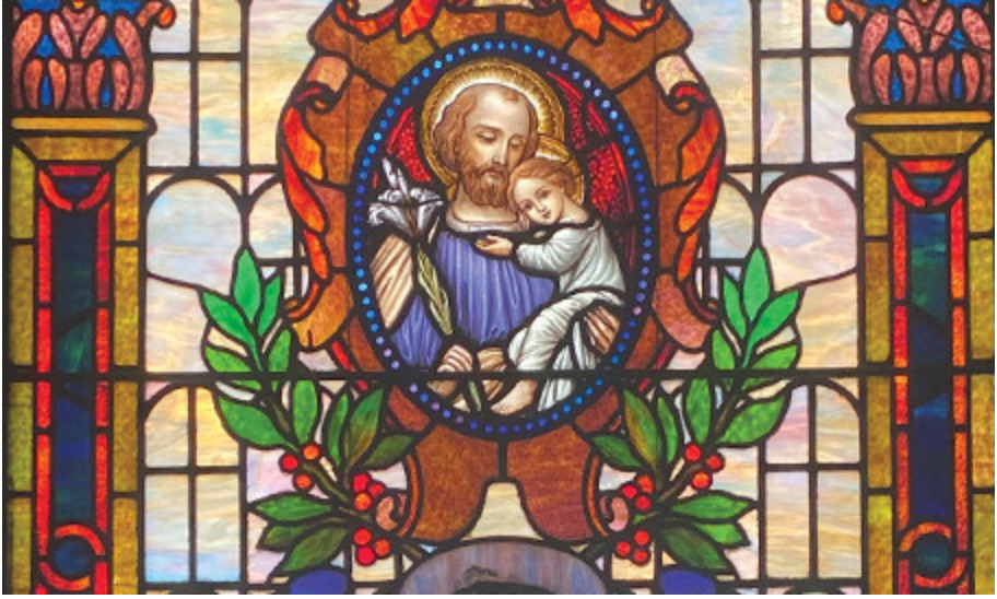 Stained glass artwork in one of SJC Brooklyn's chapels, which depicts Joseph holding Jesus.