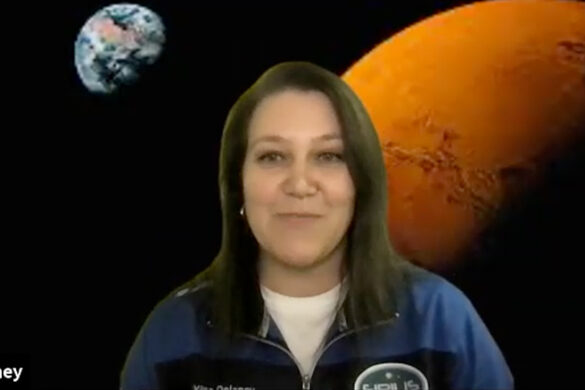 Dr. Tetyana Delaney during a virtual meeting, with a backdrop of Mars and Earth behind her.