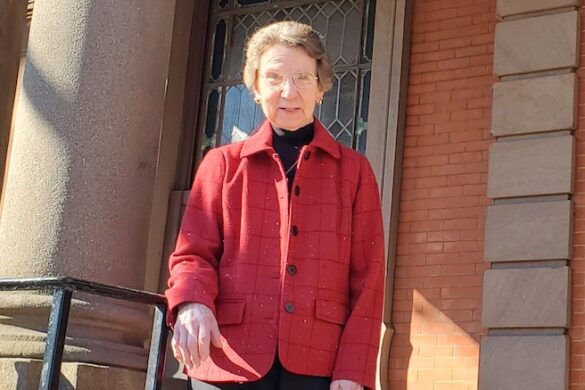 Sister Elizabeth on the steps outside hall.