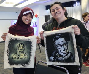 women holding painted tote bags