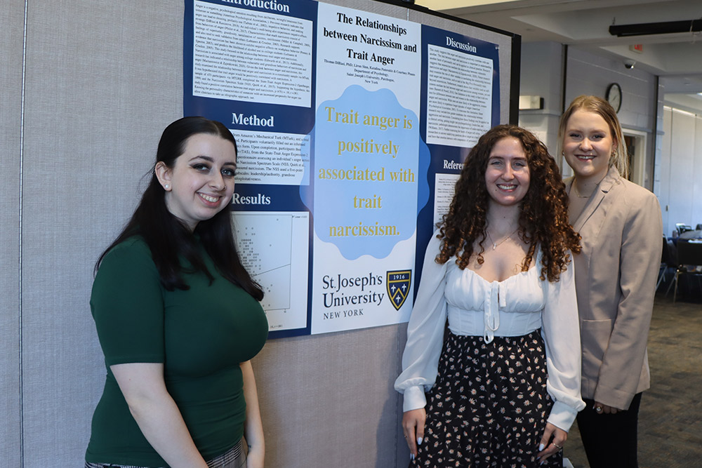 Students with poster at the Student Research Symposium.