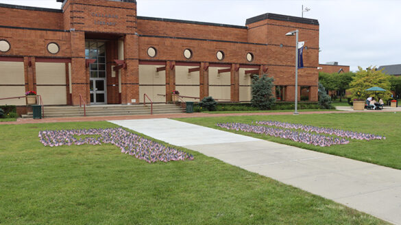 9/11 written out on the Long Island Campus quad using American flags.