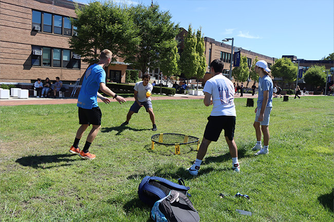 Students playing spike ball on the quad.