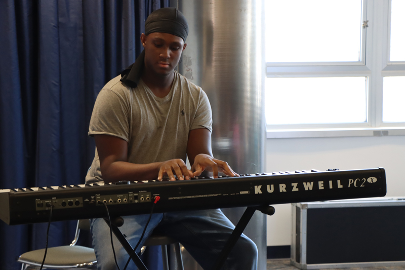 A student plays the keyboard.