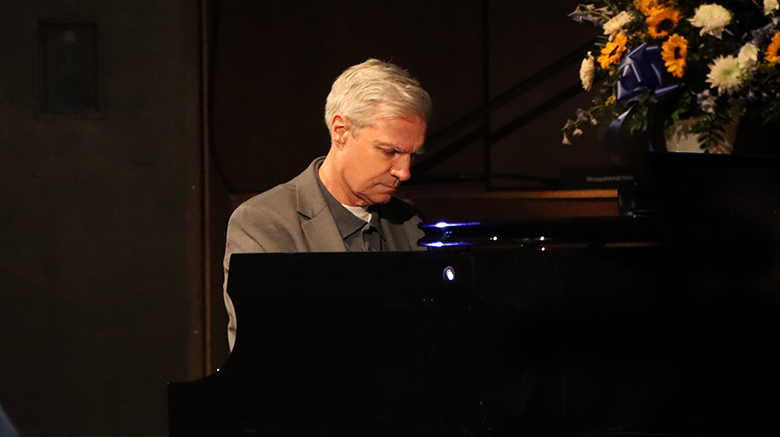 Dr. Boomgaarden playing the piano at his spring concert.