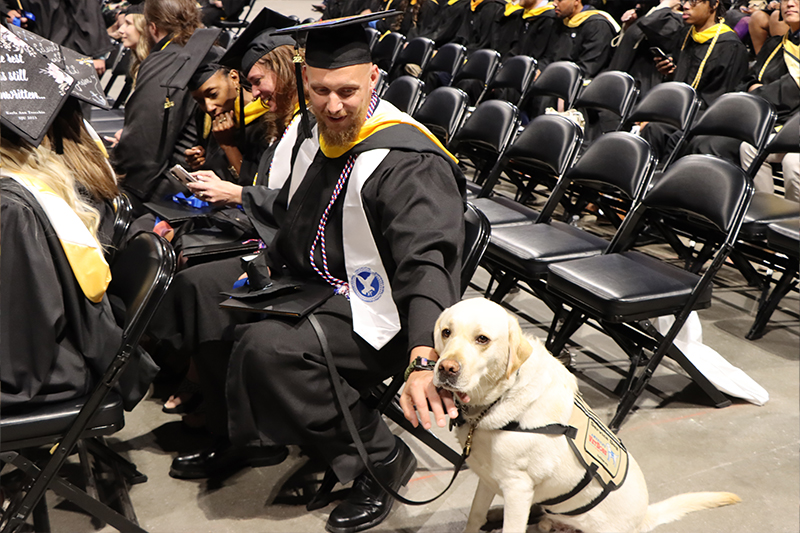 Student veteran Nathan Gardner with his service dog Kenzo.