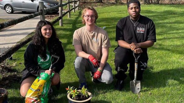 Students planting flowers at the Clare Rose Playhouse for Earth Week.