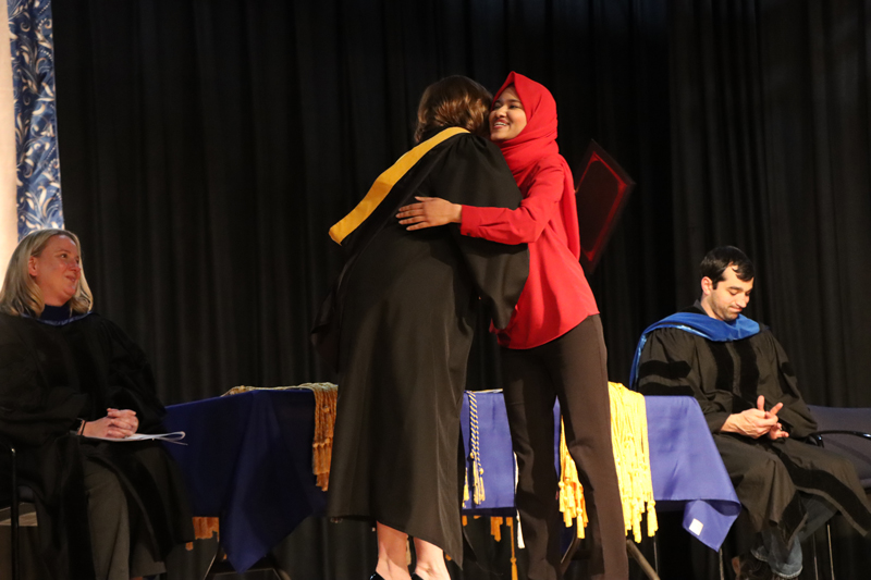 Rory presenting scholarship recipient Asma Hosein with her award.