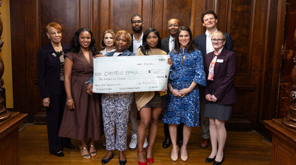 Nursing_bk6 Scholarship donors, professors, and SJNY administrators standing with an award recipient holding a large check