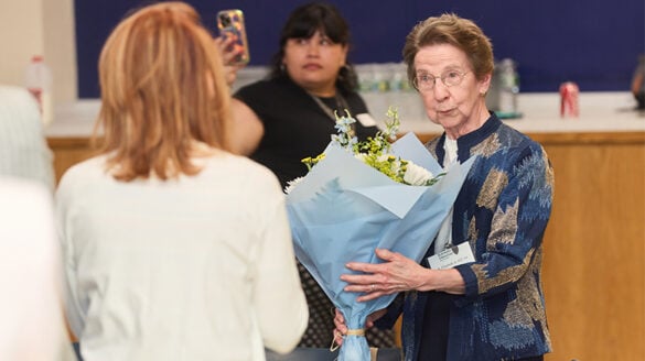 Sister Elizabeth A. Hill accepting flowers.